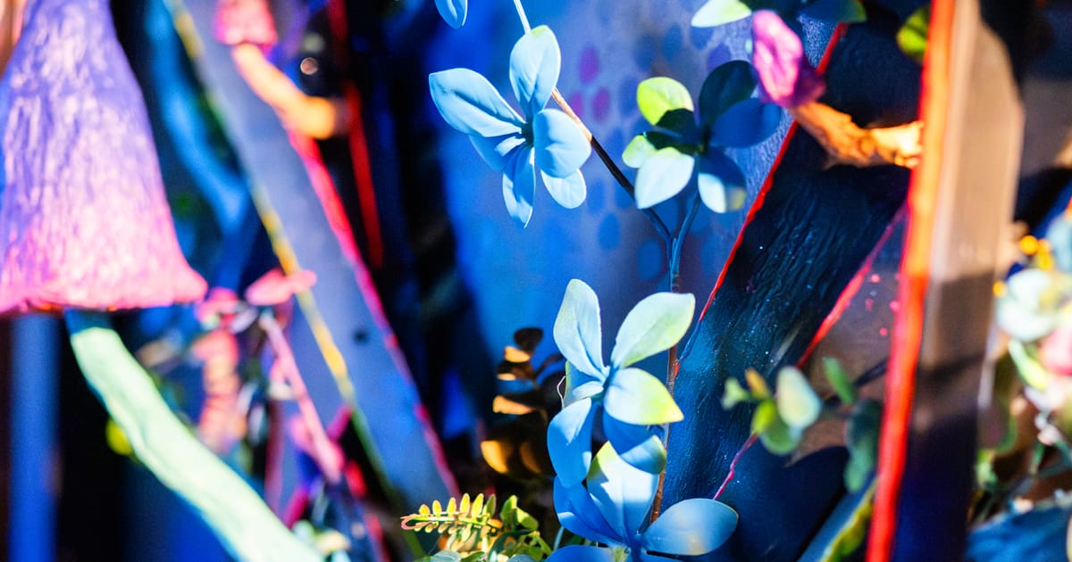 Blue artificial flowers and foliage in deep blue light